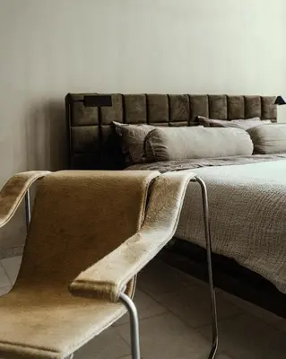 a bed with a chair in a room at Luxurious loft in Monastiraki in Athens