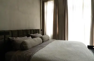 a bedroom with a bed with pillows and a window at Luxurious loft in Monastiraki in Athens
