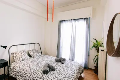 a bedroom with a bed with shoes on it at Happy Rabbit 4 in Athens