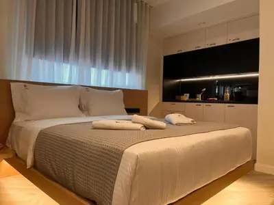 a bedroom with a large bed with two pillows on it at Triple A - Psiri Urban Spark Studios at Theatrou Square V Free Parking! in Athens