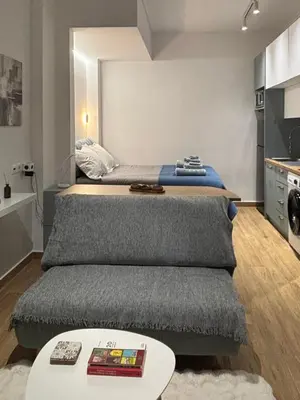 a bedroom with a bed and a table in a room at Elegant City Retreat Walk to Landmarks & Metro in Athens