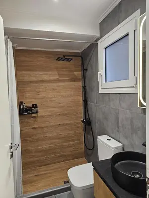 a small bathroom with a toilet and a sink at Elegant City Retreat Walk to Landmarks & Metro in Athens