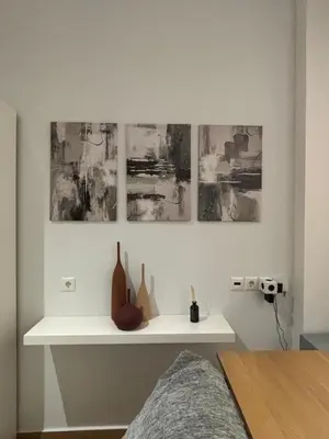 a white shelf with vases on a wall with paintings at Elegant City Retreat Walk to Landmarks & Metro in Athens