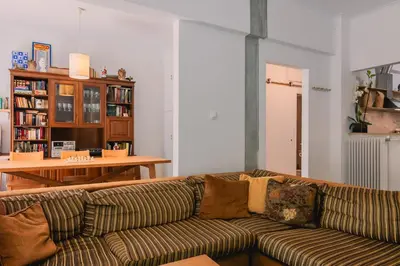 a living room with a couch and a table at Spacious Apartment in Lycabettus Hill in Athens