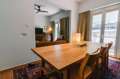 a dining room with a wooden table and chairs at Spacious Apartment in Lycabettus Hill in Athens