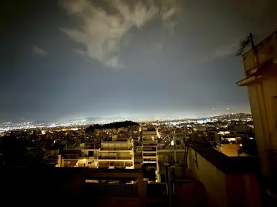 a view of a city at night at Spacious Apartment in Lycabettus Hill in Athens