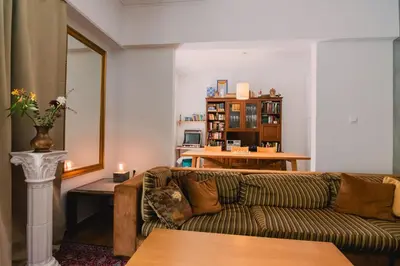 a living room with a couch and a table at Spacious Apartment in Lycabettus Hill in Athens