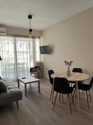 a living room with a table and a couch at Nina's Home in Athens