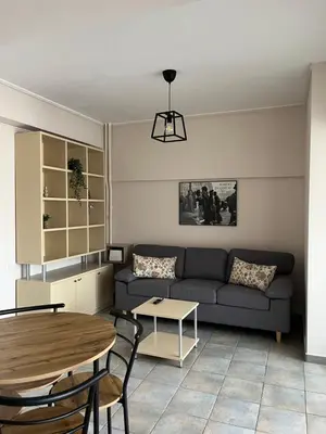 a living room with a couch and a table at Nina's Home in Athens