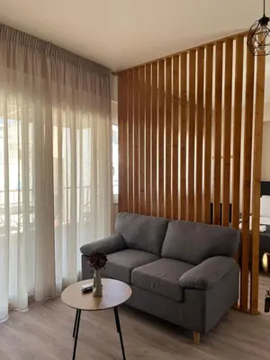 a living room with a couch and a table at Nina's Home in Athens