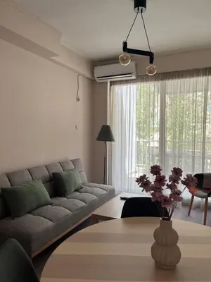 a living room with a couch and a table at Nina's Home in Athens