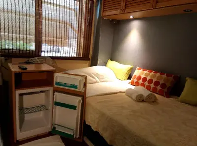 a bedroom with a bed and a nightstand with towels on it at OneStep in Athens by Oinapothiki Taverna! in Athens