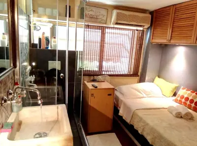a bathroom with a sink and a bed and a tub at OneStep in Athens by Oinapothiki Taverna! in Athens