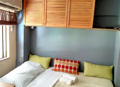 a bed in a room with some pillows on it at OneStep in Athens by Oinapothiki Taverna! in Athens