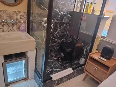 a bathroom with a fireplace and a sink at OneStep in Athens by Oinapothiki Taverna! in Athens
