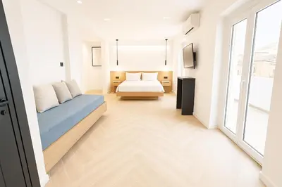 a living room with a bed and a couch at Triple A - Golden Eight - On Aiolou Downtown - FREE Parking! in Athens