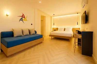 a room with a bed and a blue couch in a room at Triple A - Golden Eight - On Aiolou Downtown - FREE Parking! in Athens