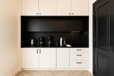 a kitchen with white cabinets and a black wall at Triple A - Golden Eight - On Aiolou Downtown - FREE Parking! in Athens