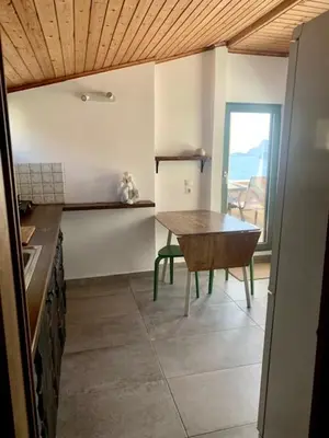 a kitchen with a table in the middle of a room at Ersi's View in Porto Rafti
