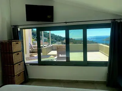 a room with a window with a view of a patio at Ersi's View in Porto Rafti