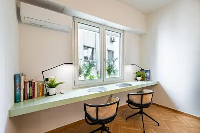 a room with a desk with two chairs and a window at STELLIE Elegant Mid-century modern 2bd-2bath in Athens