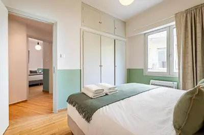 a bedroom with a bed with towels on it at STELLIE Elegant Mid-century modern 2bd-2bath in Athens