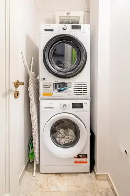 a washing machine and a dryer in a room at STELLIE Elegant Mid-century modern 2bd-2bath in Athens