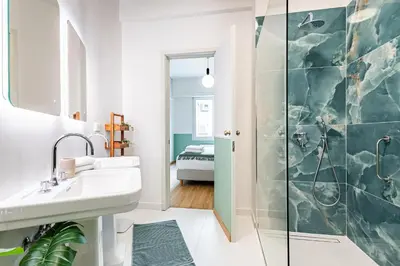 a bathroom with a sink and a shower at STELLIE Elegant Mid-century modern 2bd-2bath in Athens