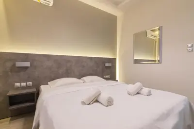 a bedroom with a large white bed with two pillows at Centrally Located Apt for 3 People in Athens