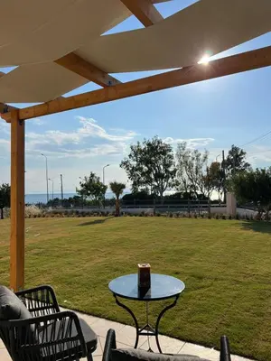 a table with a cake on top of a field at Serene Seaside Villa Raf with Unique Sunset View in Nisídhes Markéllou