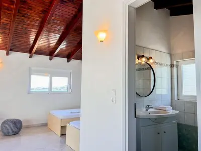 a bathroom with a sink and a mirror at Serene Seaside Villa Raf with Unique Sunset View in Nisídhes Markéllou