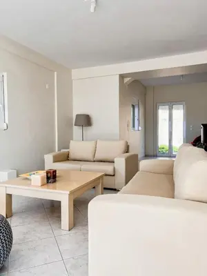 a living room with two beds and a coffee table at Serene Seaside Villa Raf with Unique Sunset View in Nisídhes Markéllou