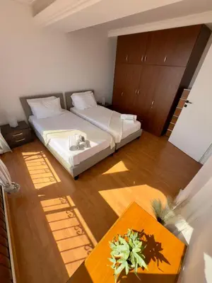 a small bedroom with a bed and a table at Exclusive Penthouse Apt, at Glyfada Marina & Beach in Athens