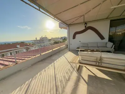 a balcony with a bed and a table on a roof at Exclusive Penthouse Apt, at Glyfada Marina & Beach in Athens