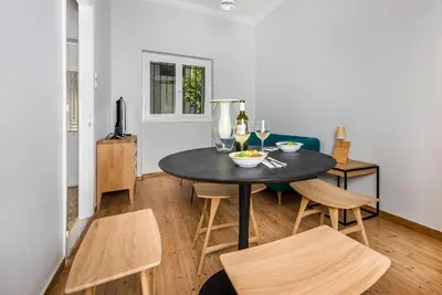 a dining room with a black table and chairs at The Athenian Veranda in Athens