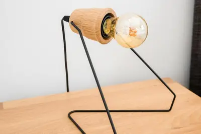a lamp on top of a wooden table with a bottle at The Athenian Veranda in Athens