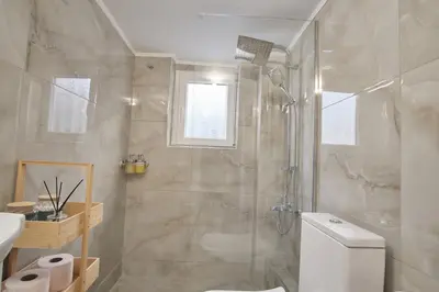 a bathroom with a shower and a toilet and a sink at ConEviKa in Athens