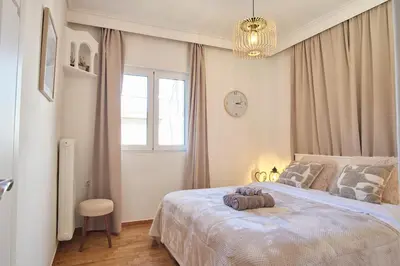 a bedroom with a bed and a clock on the wall at ConEviKa in Athens