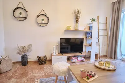 a living room with a tv and a table at ConEviKa in Athens