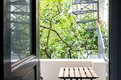 a wooden bench sitting in front of a window at The Athenian Veranda 2 in Athens