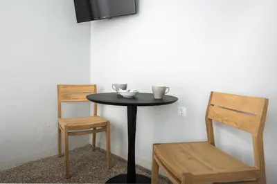 a small table with two chairs and a television at The Athenian Veranda 2 in Athens