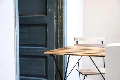 a table and two chairs next to a door at The Athenian Veranda 2 in Athens