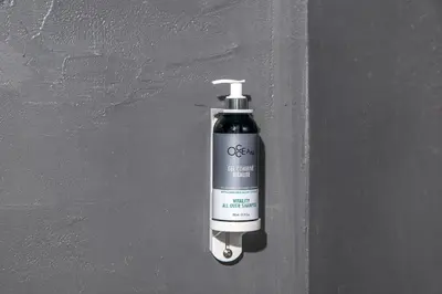 a black and white soap bottle on a wall at The Athenian Veranda 2 in Athens