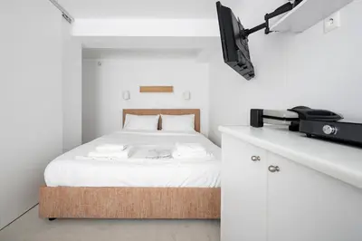 a bedroom with a bed and a tv on a counter at The Athenian Veranda 3 in Athens