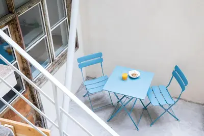 a blue table and chairs with a plate of food on it at The Athenian Veranda 3 in Athens