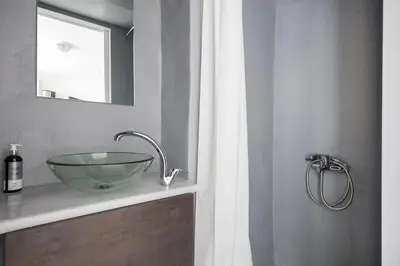 a bathroom with a glass bowl sink on a counter at The Athenian Veranda 3 in Athens