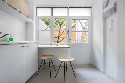 a kitchen with two stools and a counter and a window at The Athenian Veranda 3 in Athens