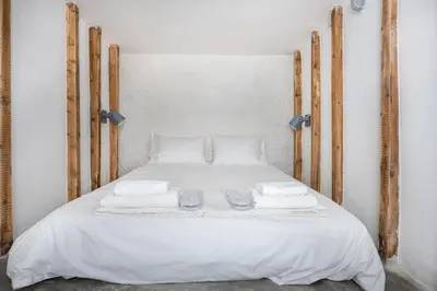 a bed with white sheets and towels on it at The Athenian Veranda 4 in Athens