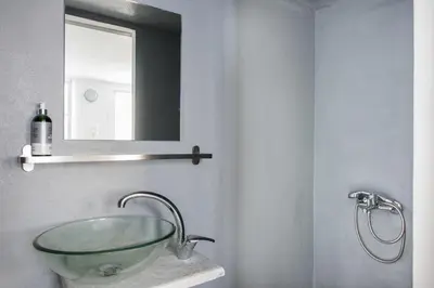 a bathroom with a glass sink and a mirror at The Athenian Veranda 4 in Athens