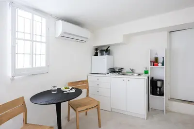 a kitchen with a table and a small table in a room at The Athenian Veranda 4 in Athens